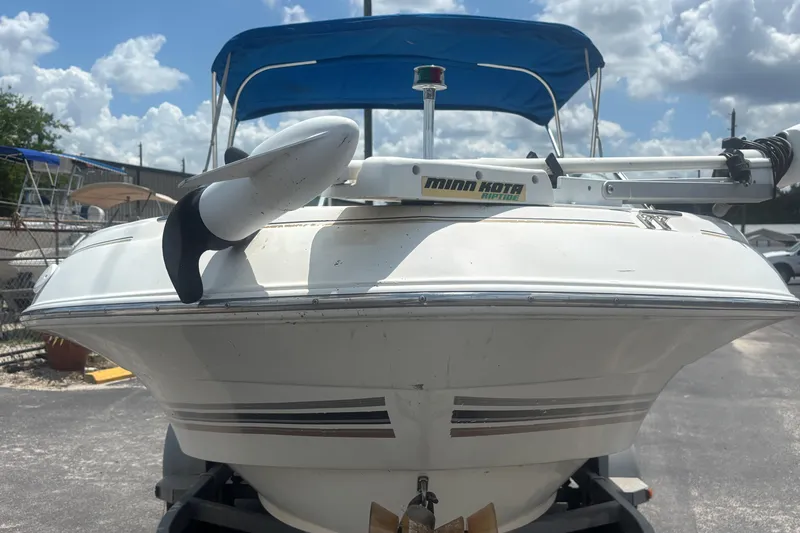 Slide: The Image of 2002 Wellcraft 180 Sportsman boat with Minn Kota Riptide motor, docked under a blue sky. - 7