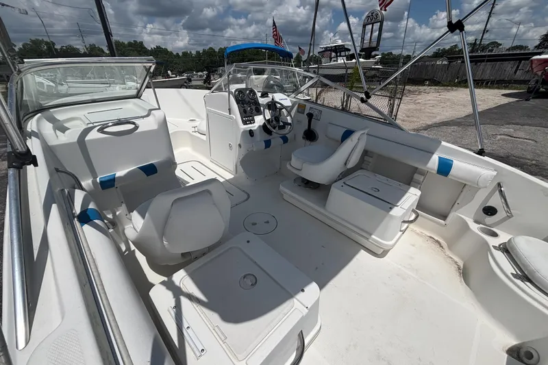 Slide: The Image of 2002 Wellcraft 180 Sportsman boat interior with white seating and control panel. - 9