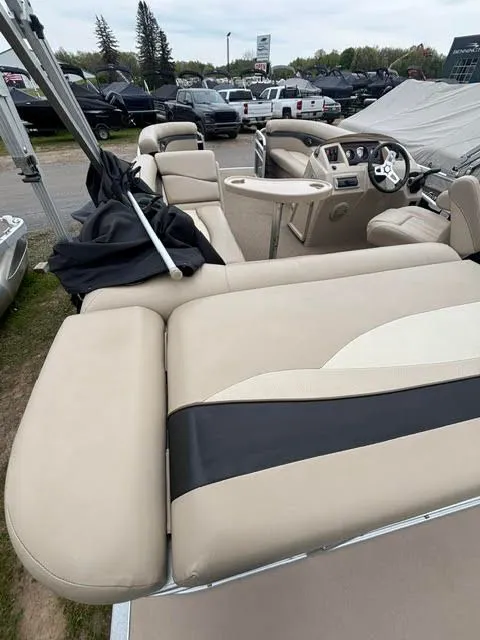 Slide: The Image of Interior of a 2013 Bennington 20SLMX pontoon boat with beige seating. - 11