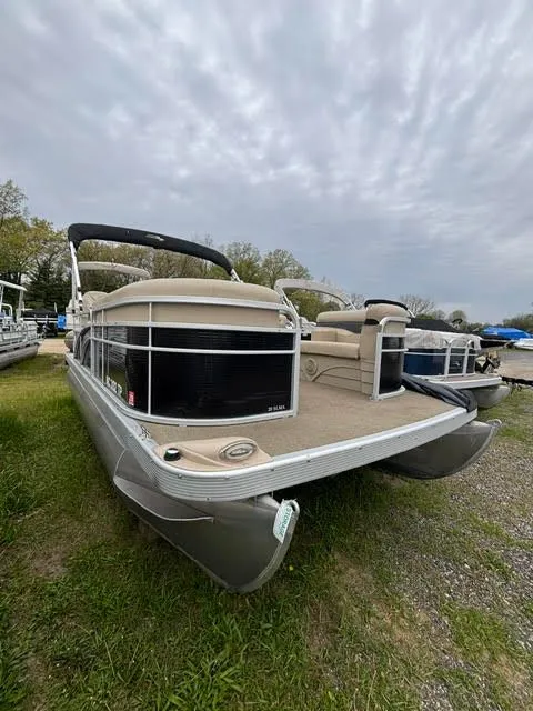 Slide: The Image of 2013 Bennington 20SLMX pontoon boat parked on grass. - 3