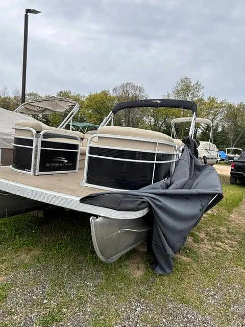 Slide: The Image of 2013 Bennington 20SLMX pontoon boat parked on grass. - 4