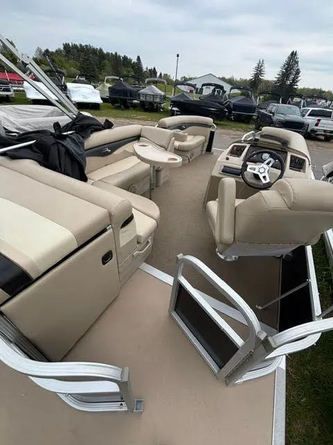 Slide: The Image of Interior of a 2013 Bennington 20SLMX pontoon boat with beige seating. - 7