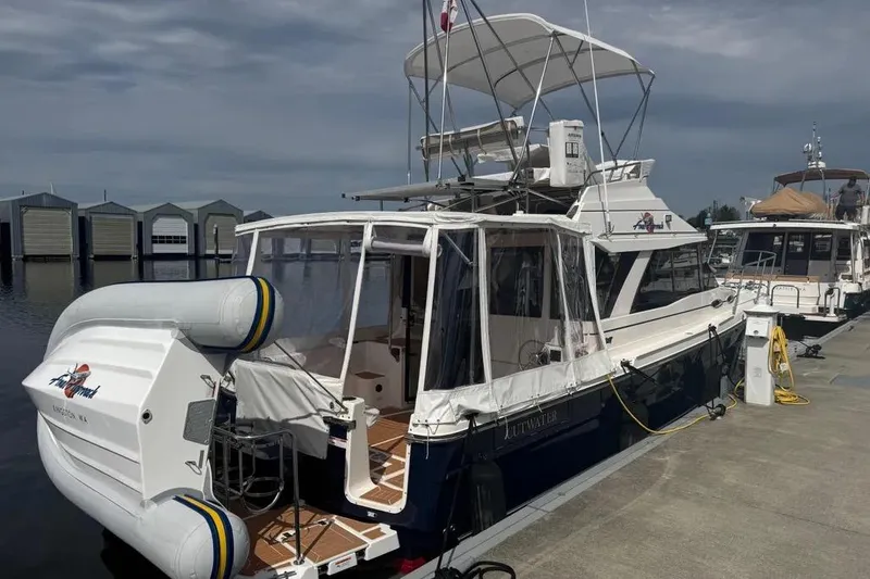 The Image of 2020 Cutwater C-30 CB boat docked with inflatable dinghy, marina backdrop. - 1