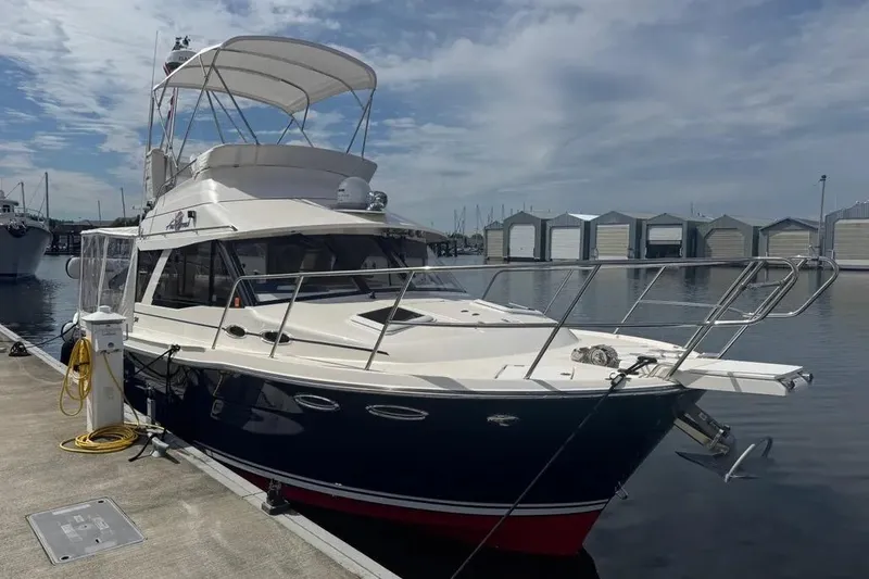Slide: The Image of 2020 Cutwater C-30 CB yacht docked at marina under cloudy sky. - 2