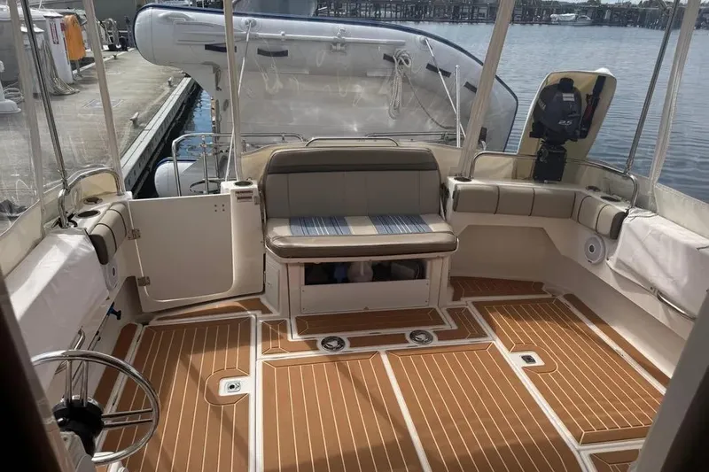 Slide: The Image of 2020 Cutwater C-30 CB boat interior with cushioned seating and wood-patterned flooring. - 20