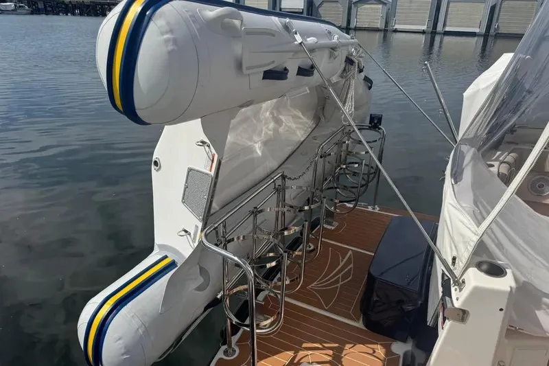 Slide: The Image of 2020 Cutwater C-30 CB boat with inflatable dinghy on deck, docked at marina. - 21