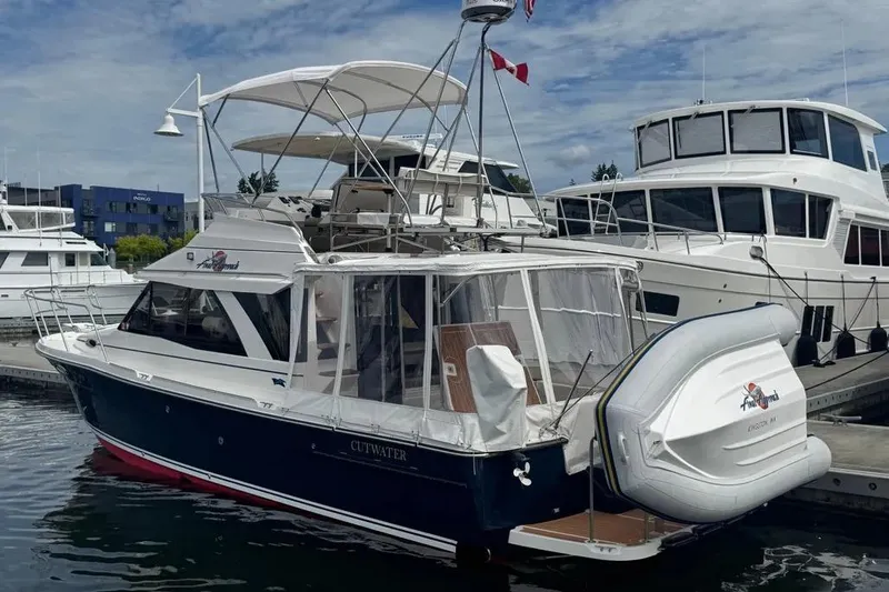 Slide: The Image of 2020 Cutwater C-30 CB boat docked with inflatable dinghy, marina background. - 4