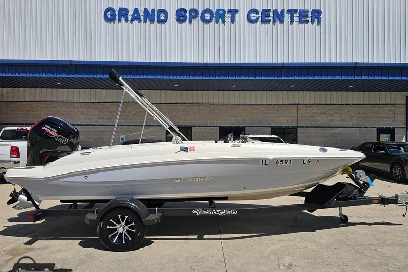 Slide: The Image of 2023 Stingray 182 SC boat on trailer at Grand Sport Center. - 2
