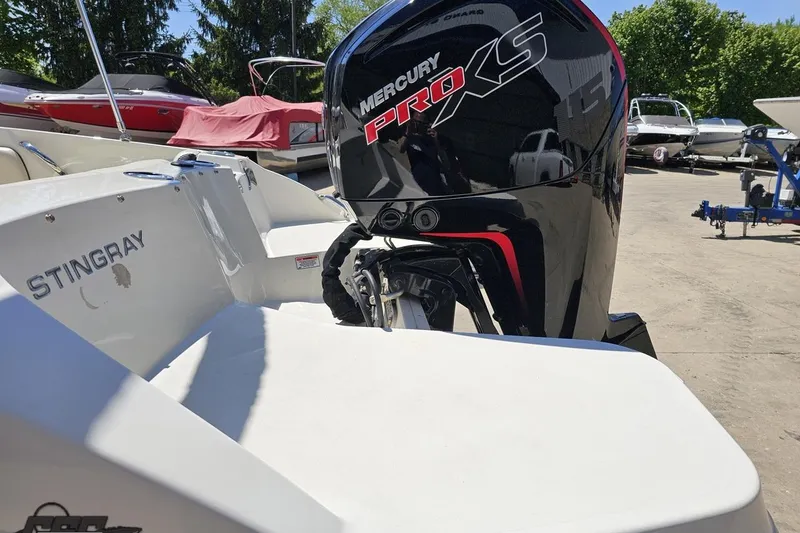 Slide: The Image of 2023 Stingray 182 SC boat with Mercury Pro XS engine in a marina setting. - 29
