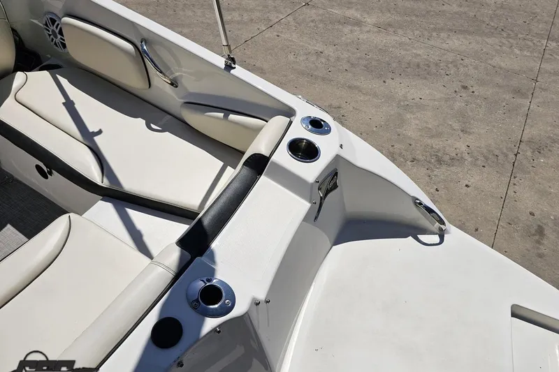 Slide: The Image of 2023 Stingray 182 SC boat interior with white seating and cup holders. - 36
