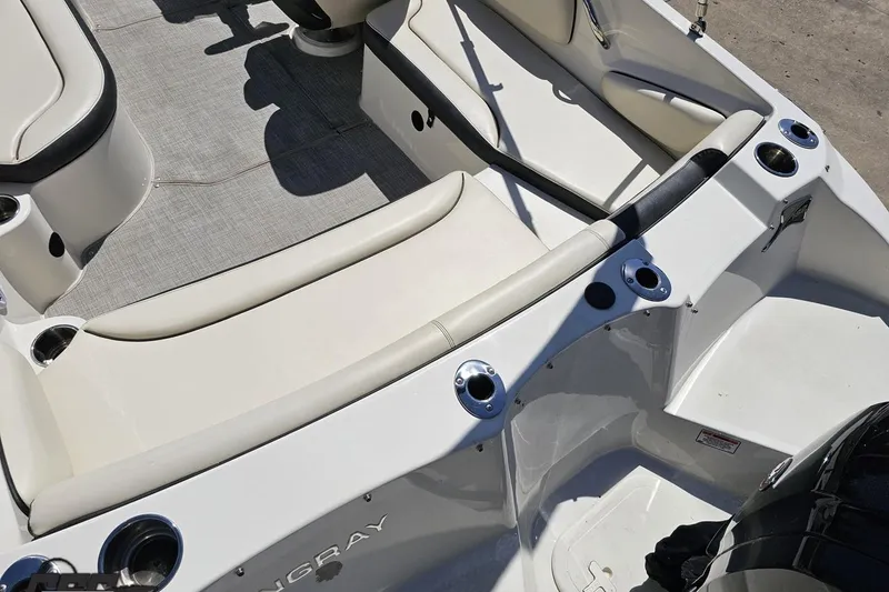 Slide: The Image of 2023 Stingray 182 SC boat interior with white seating and cup holders. - 38