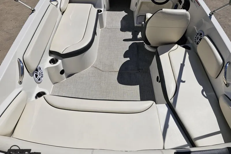 Slide: The Image of 2023 Stingray 182 SC boat interior with white seating and gray flooring. - 40
