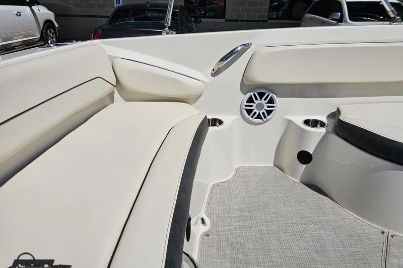 Slide: The Image of 2023 Stingray 182 SC boat interior with cushioned seating and speaker system. - 42