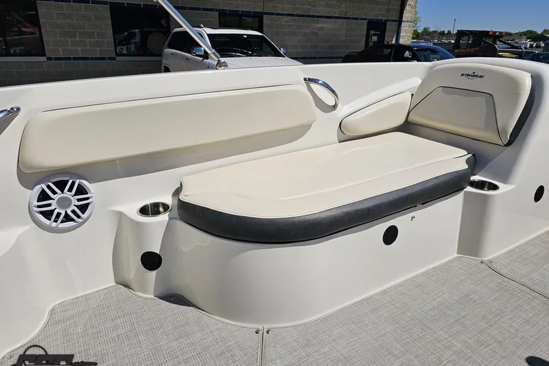 Slide: The Image of 2023 Stingray 182 SC boat interior with cushioned seating and speaker. - 43