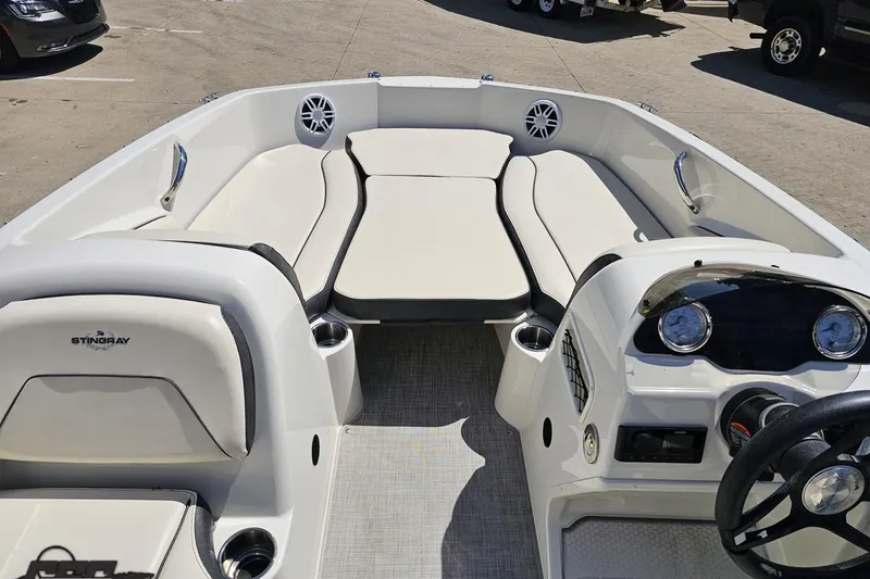Slide: The Image of 2023 Stingray 182 SC boat interior with spacious seating and modern dashboard. - 49