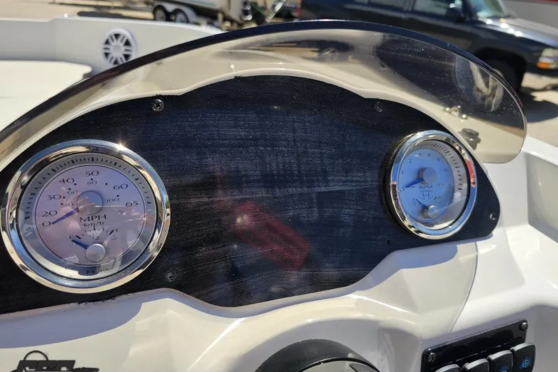 Slide: The Image of Dashboard of a 2023 Stingray 182 SC boat with speedometer and tachometer. - 56