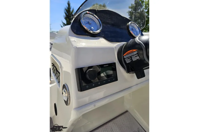 Slide: The Image of 2023 Stingray 182 SC boat dashboard with gauges and control panel. - 57