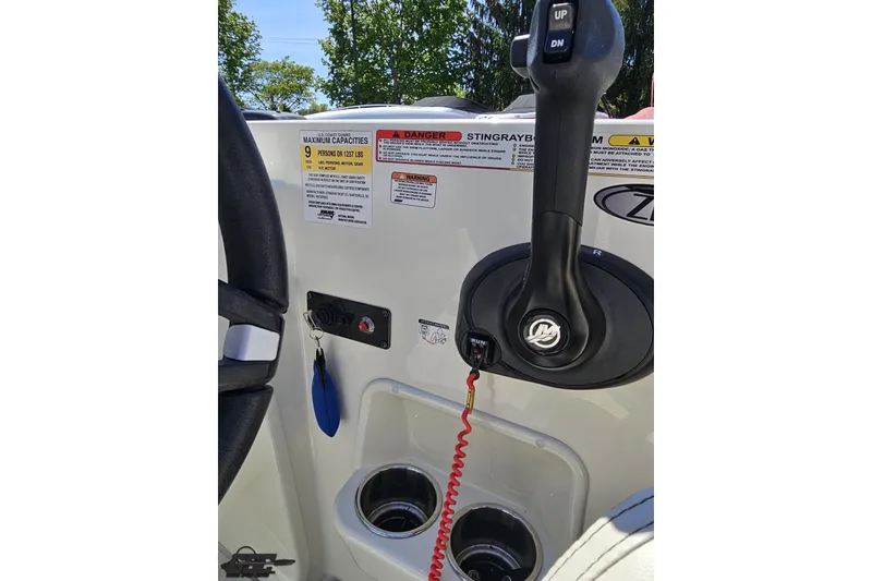 Slide: The Image of 2023 Stingray 182 SC boat control panel with throttle lever and safety warnings. - 59