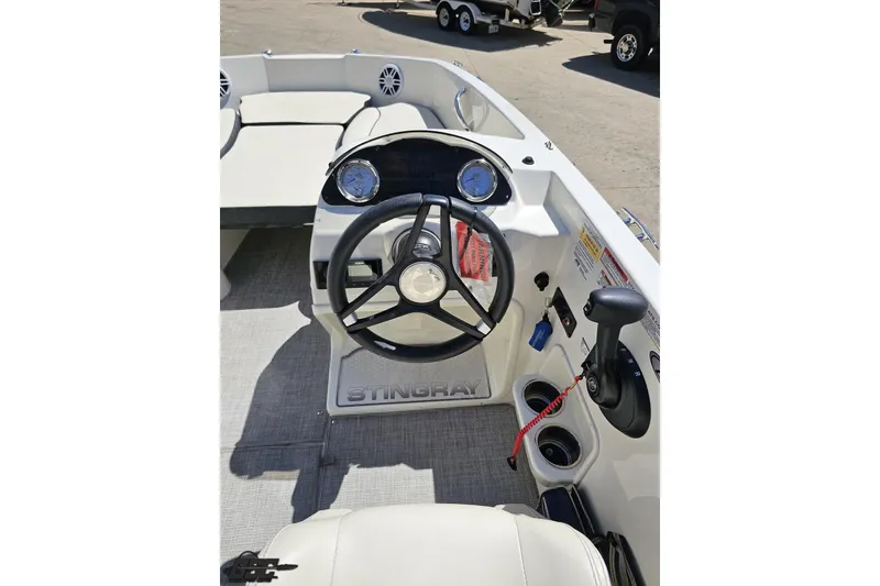 Slide: The Image of 2023 Stingray 182 SC boat interior with steering wheel and control panel. - 60