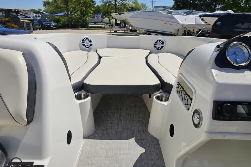 Slide: The Image of 2023 Stingray 182 SC boat interior with cushioned seating and modern dashboard. - 61