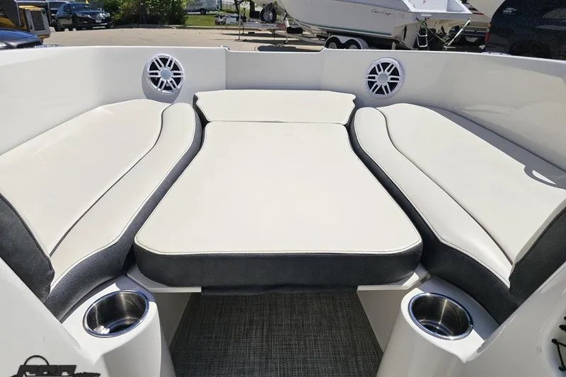 Slide: The Image of 2023 Stingray 182 SC boat interior with cushioned seating and cup holders. - 62