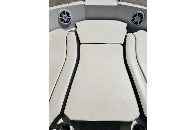Slide: The Image of 2023 Stingray 182 SC boat interior with cushioned seating and built-in speakers. - 65