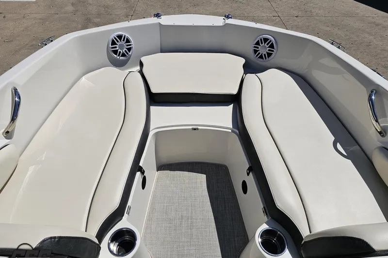 Slide: The Image of 2023 Stingray 182 SC boat interior with cushioned seating and cup holders. - 67
