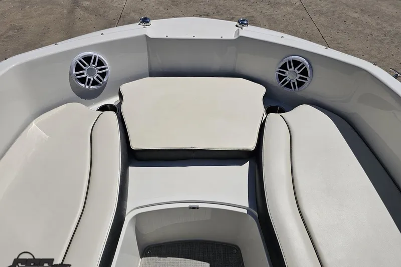 Slide: The Image of 2023 Stingray 182 SC boat interior with cushioned seating and built-in speakers. - 68