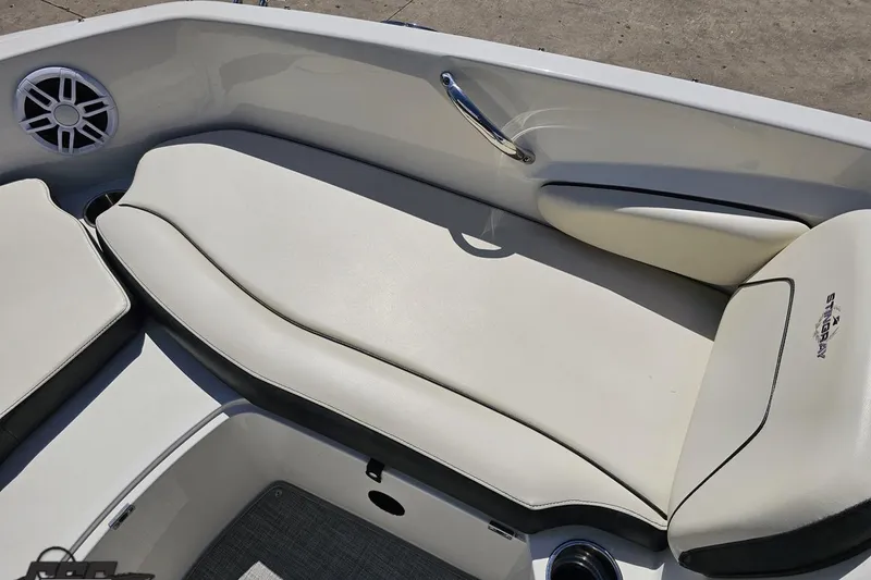 Slide: The Image of 2023 Stingray 182 SC boat interior with white cushioned seating and speaker. - 69