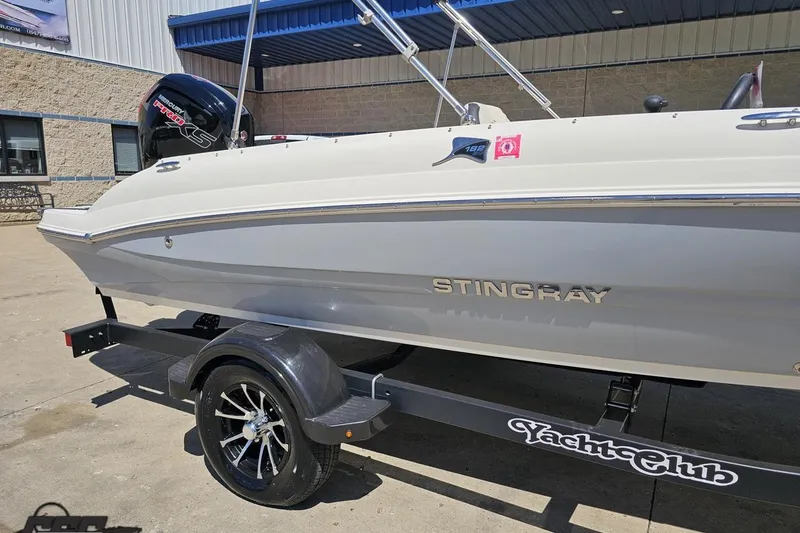 Slide: The Image of 2023 Stingray 182 SC boat on trailer, featuring sleek design and modern outboard motor. - 7
