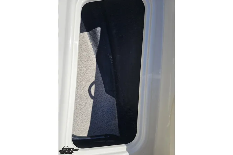 Slide: The Image of 2023 Stingray 182 SC boat interior storage compartment with carpeted lining. - 70