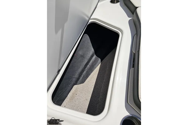 Slide: The Image of Storage compartment in 2023 Stingray 182 SC boat, featuring sleek interior design. - 72