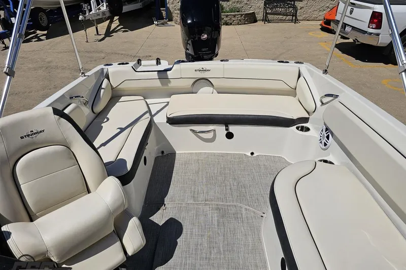 Slide: The Image of 2023 Stingray 182 SC boat interior with beige seating and modern design. - 76