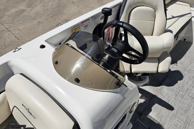 Slide: The Image of 2023 Stingray 182 SC boat interior with steering wheel and seating. - 77