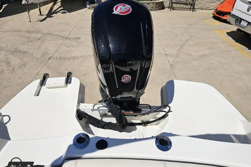 Slide: The Image of 2023 Stingray 182 SC boat with powerful outboard motor in a sunny outdoor setting. - 84