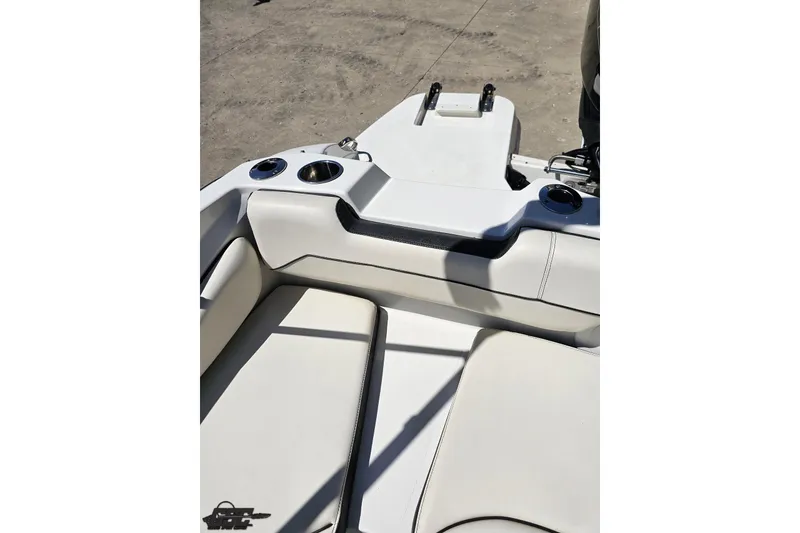 Slide: The Image of 2023 Stingray 182 SC boat interior with white seating and cup holders. - 85