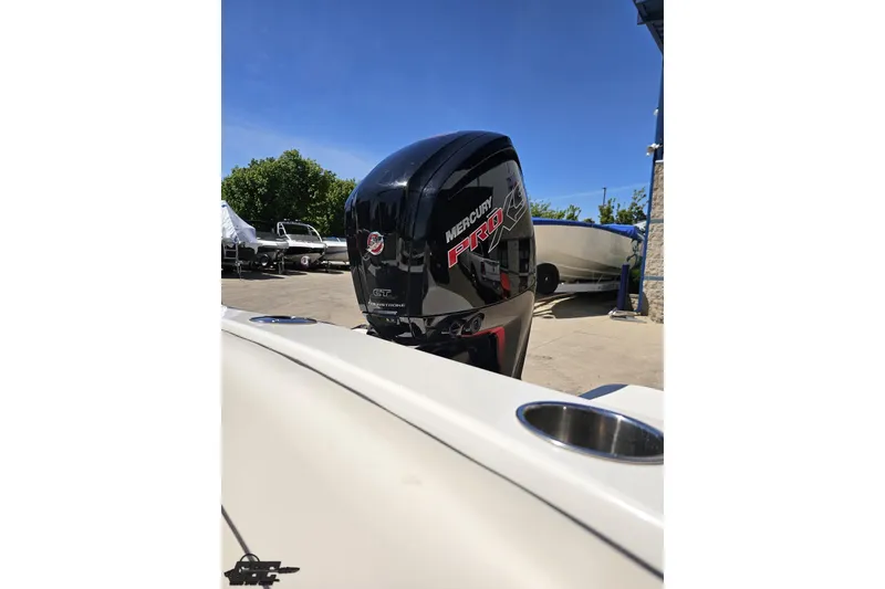 Slide: The Image of 2023 Stingray 182 SC boat with Mercury Pro outboard motor in a sunny marina. - 86