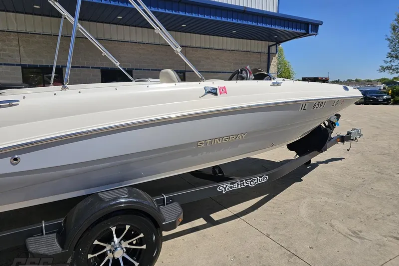 Slide: The Image of 2023 Stingray 182 SC boat on trailer, parked outside a building. - 9