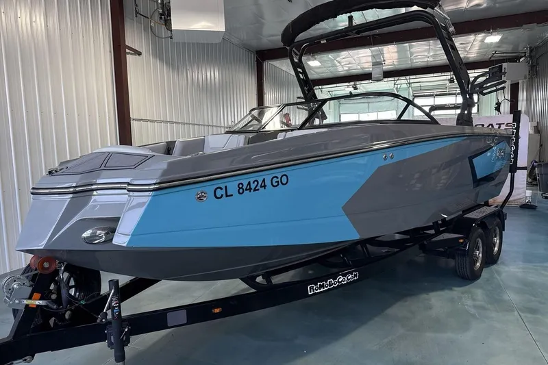 The Image of 2024 Heyday WTSurf boat in a showroom, featuring sleek blue and gray design. - 1