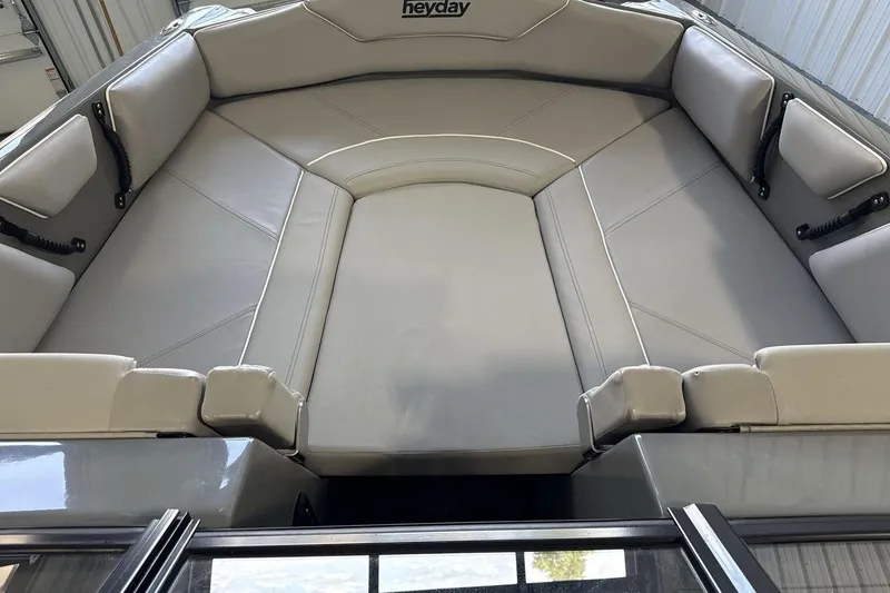 Slide: The Image of 2024 Heyday WTSurf boat interior with spacious, cushioned seating in a sleek design. - 11