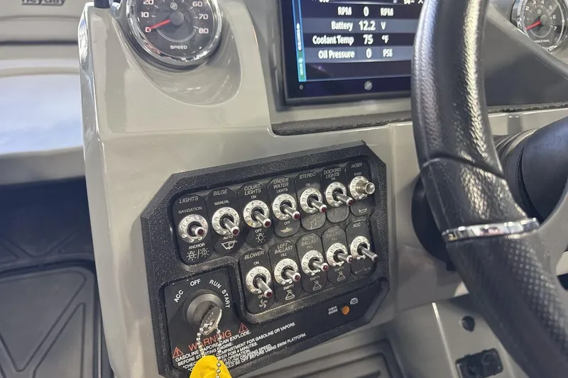 Slide: The Image of 2024 Heyday WTSurf boat dashboard with control switches and steering wheel. - 15