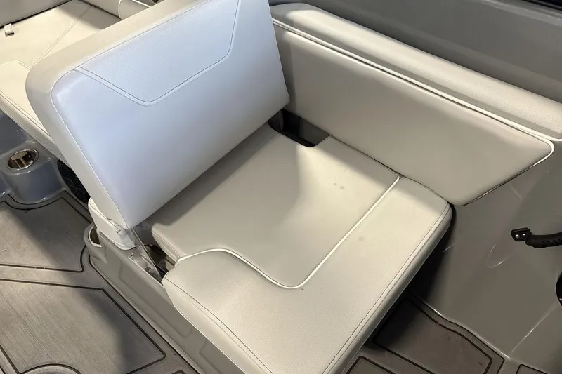 Slide: The Image of 2024 Heyday WTSurf boat interior seating with gray upholstery and cup holder. - 17