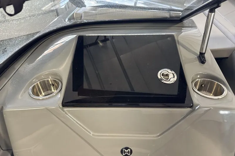 Slide: The Image of Dashboard of 2024 Heyday WTSurf boat with cup holders and storage compartment. - 18