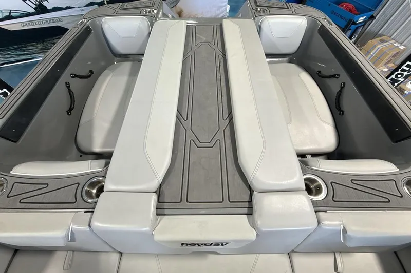 Slide: The Image of 2024 Heyday WTSurf boat interior with gray seating and cup holders. - 19