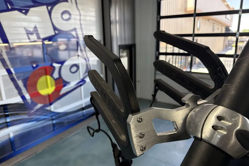 Slide: The Image of 2024 Heyday WTSurf boat detail with modern wakeboard rack in showroom. - 21