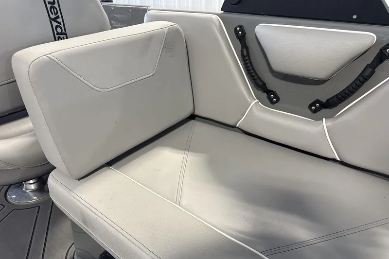 Slide: The Image of 2024 Heyday WTSurf boat interior with gray seating and black handles. - 22