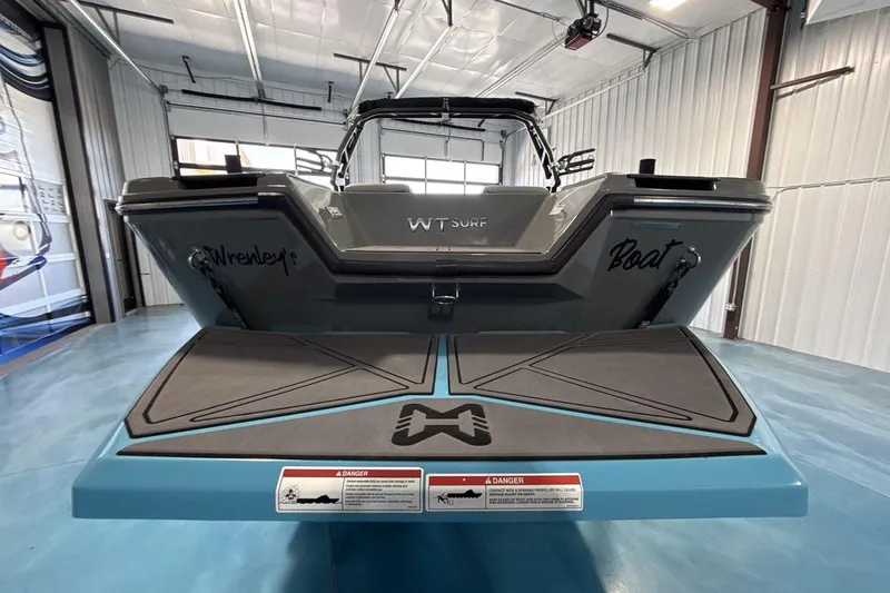 Slide: The Image of 2024 Heyday WTSurf boat in a showroom, showcasing sleek design and branding. - 4