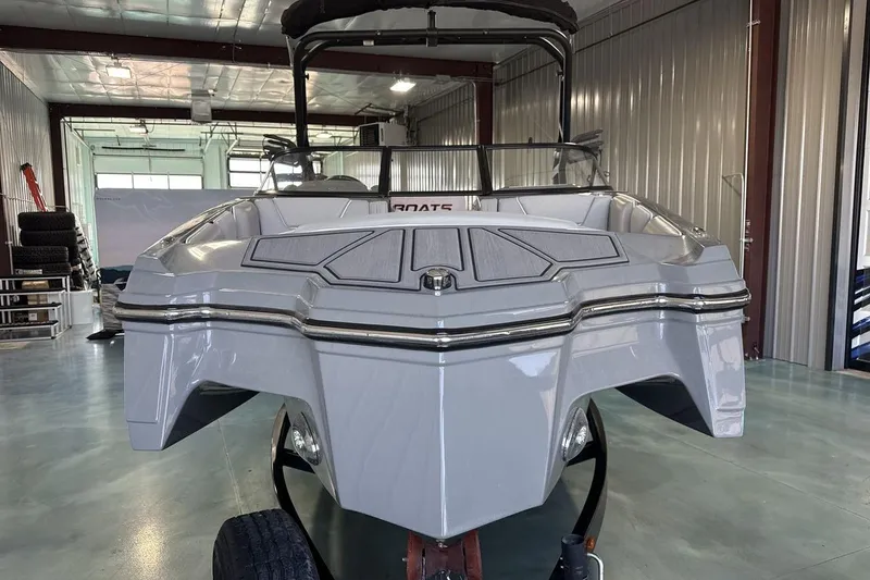 Slide: The Image of 2024 Heyday WTSurf boat in a garage, showcasing sleek design and modern features. - 8