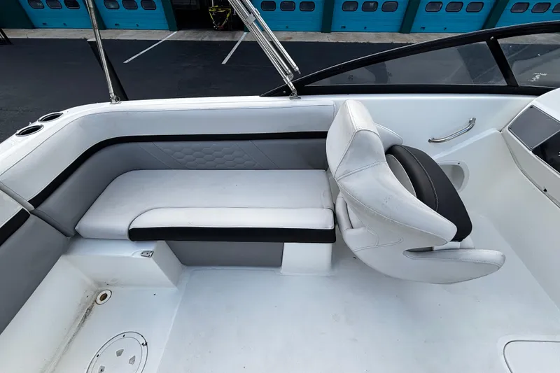 Slide: The Image of Interior seating of 2022 Hurricane SunDeck 217 OB boat, featuring white and black upholstery. - 6
