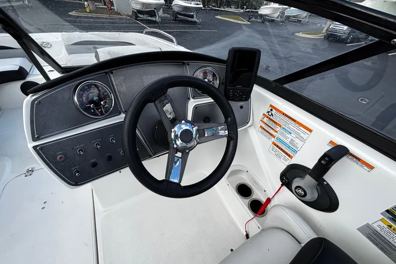 Slide: The Image of Cockpit view of 2022 Hurricane SunDeck 217 OB boat with steering wheel and controls. - 7